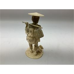 Japanese Tokyo School ivory figure on a circular base, 19th century, carved as a man carrying a basket with bird by his feet, with a three character signature beneath, H18cm