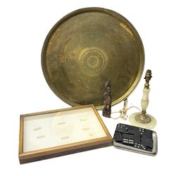 Engraved brass charger, D57cm, together with glazed oak display case, onyx table lamp, carved wood figure etc