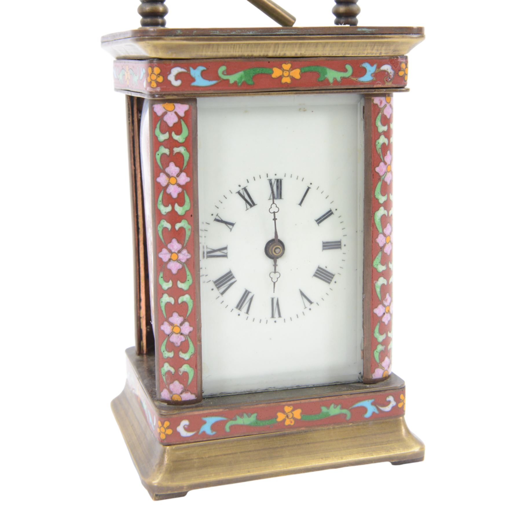 Late 20th century- Chinese 8-day timepiece carriage clock with Cloisonne work on a red ground to the four pillars, base and cornice, with painted porcelain panels to the sides, white enamel dial with Roman numerals and trefoil steel hands, platform escapement wound and set from the rear. With Key.