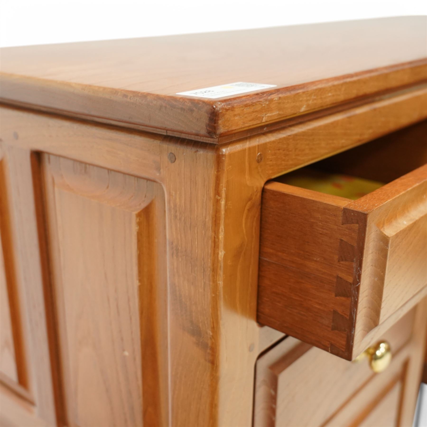 Craftsman made - elm kneehole dressing table, rectangular top over nine drawers, panelled sides, on stile supports 