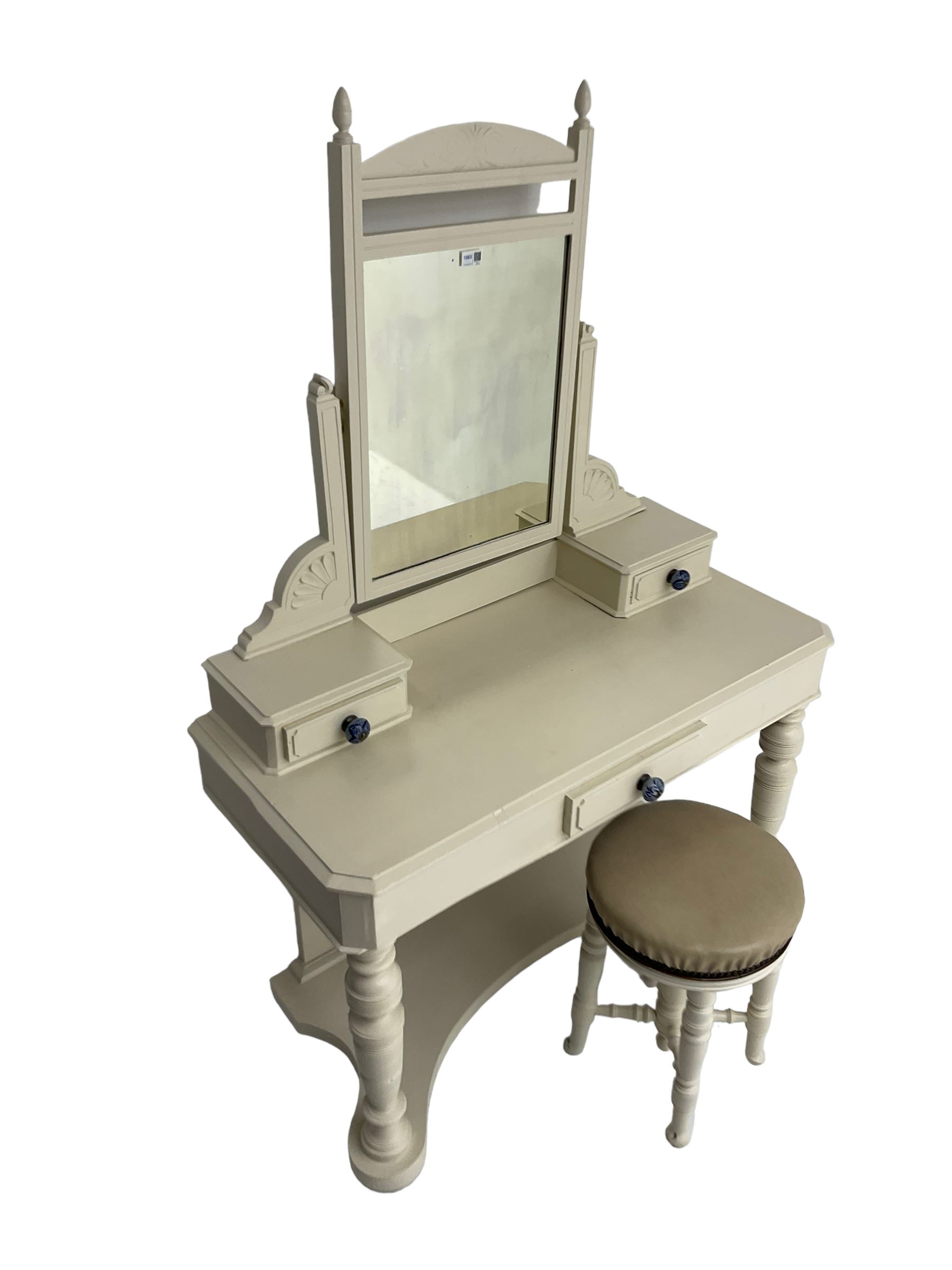 Edwardian cream painted dressing table, fitted with rectangular swing mirror over two trinket drawers with ceramic handles, rectangular top with frieze drawer, raised on turned front supports; with circular stool, leather seat over four turned supports