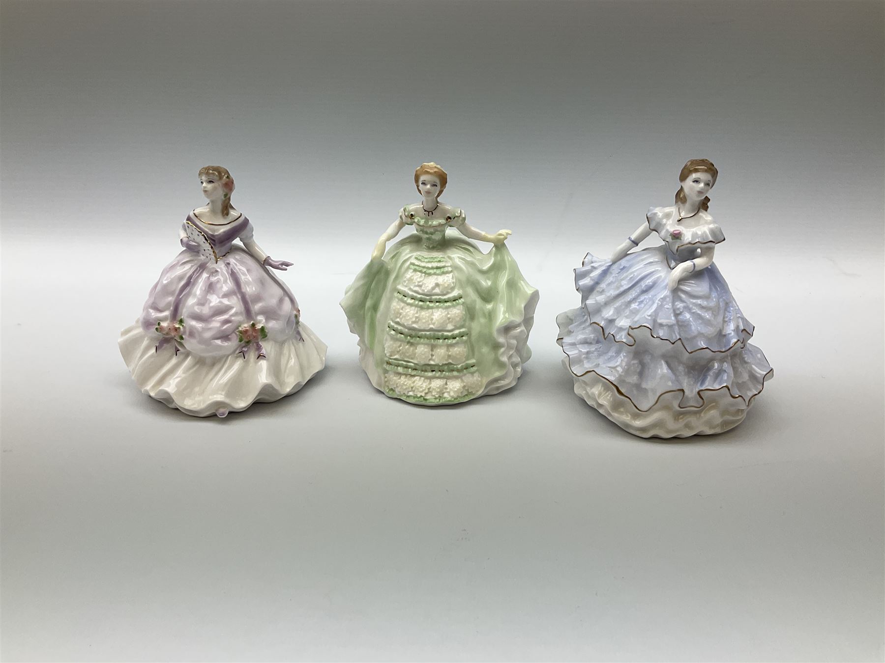 A group of figures, comprising four Royal Worcester examples, The Milkmaid, Lady Emma, Lady Cicely, Lady Hannah, three Royal Doulton examples, Top o' the Hill HN1849, Margaret HN2397, Fair Lady HN3216, two Coalport examples Fairest Flowers Heather, and Pansy, and a Wedgwood figure commissioned by Spink, The Imperial Banquet. 