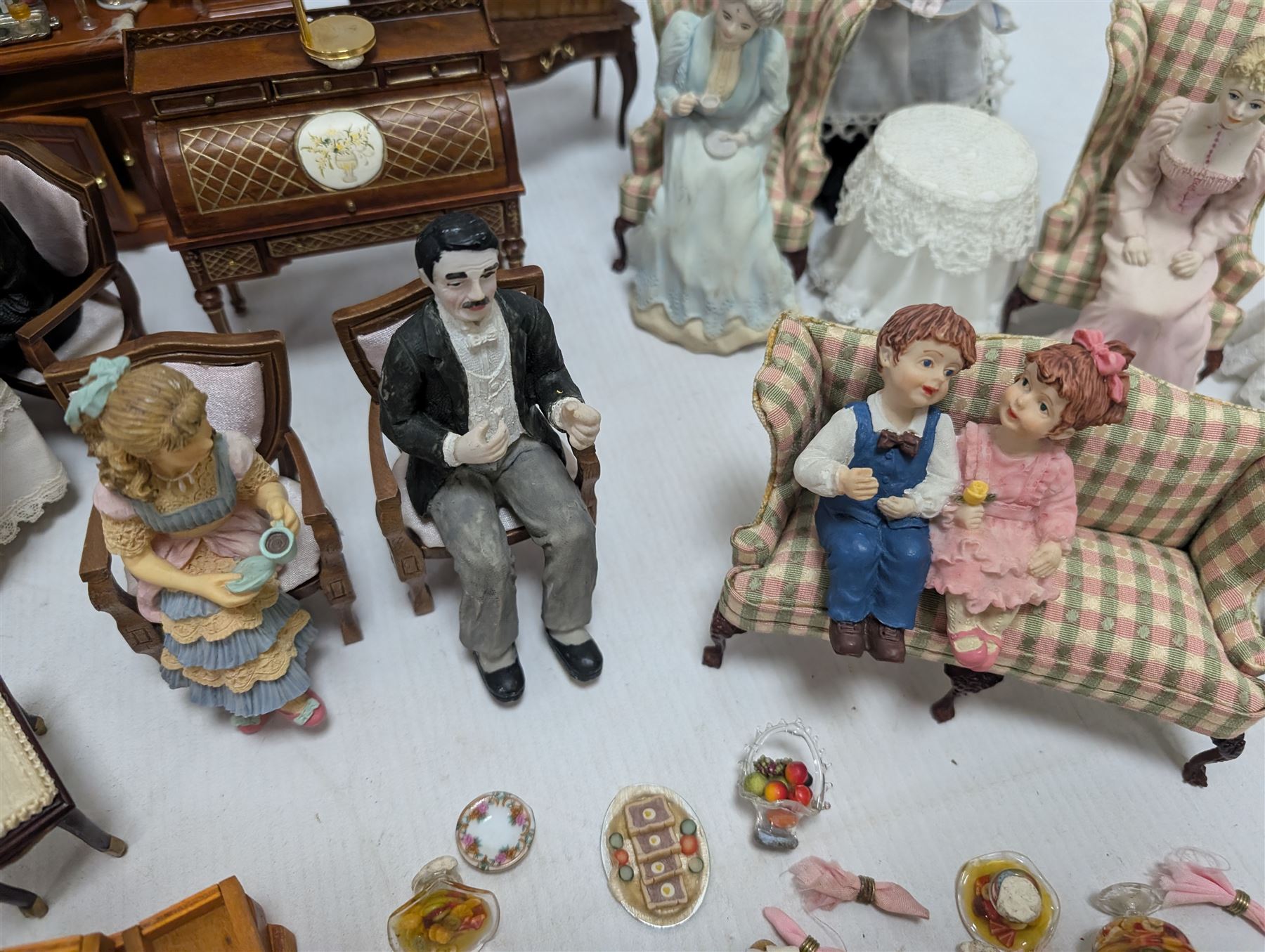 Dolls house drawing room furniture, including dressers, pink and green checked sofa and armchairs, bureau, chairs, piano, eight figures and a collection of afternoon tea miniatures