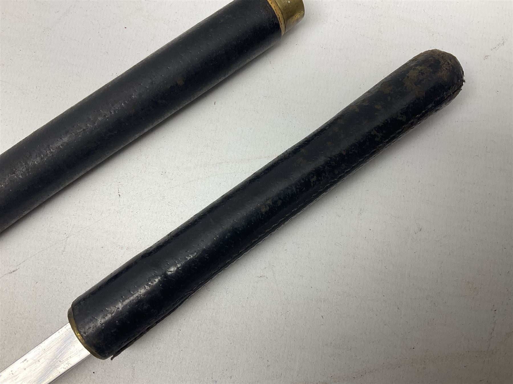 Early 20th century British Army Officer’s leather covered swagger / sword stick by Swaine & Adeney of 185 Piccadilly London; 34.5cm double edged spear point blade with etched foliate decoration and retailer’s details; stamped 'Forged in London' to the edge of the ricasso; L59.5cm overall