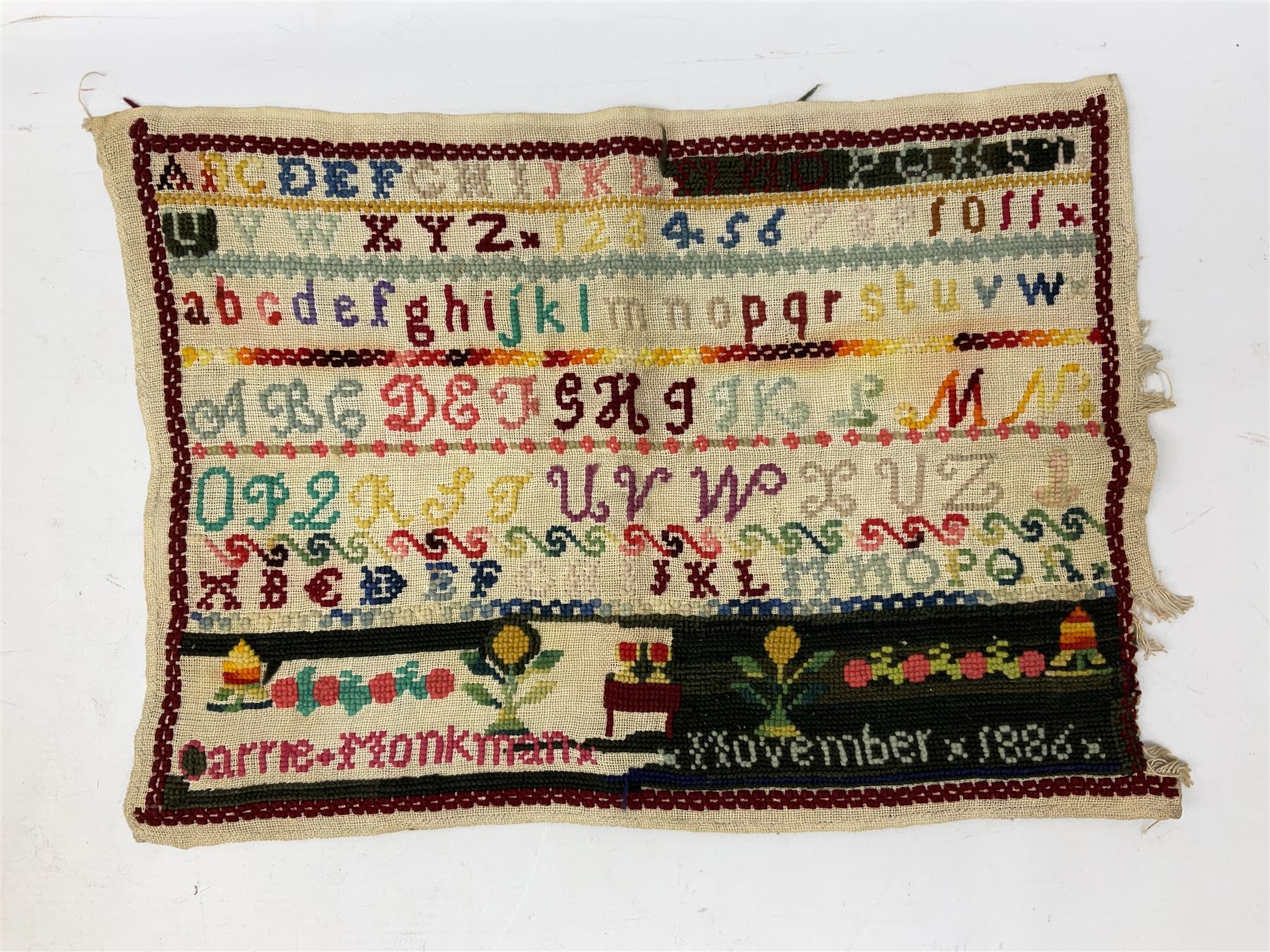  Victorian sampler worked with the alphabet by Carrie Monkman 1886, Victorian silver-plated cigarette case, Carlo simulated tortoiseshell motorised fan in case, Folding Opera Glasses, two chrome leaping Jaguar brooch and matching pin badge, quantity of sewing threads, lace etc