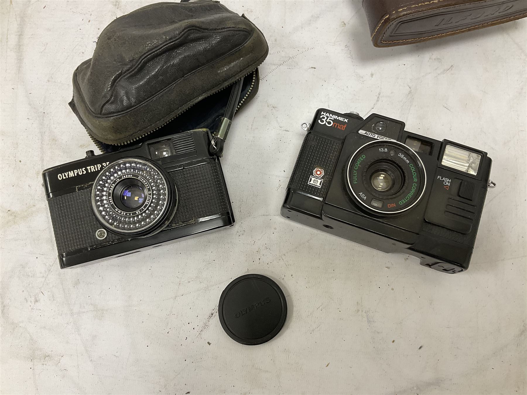 Quantity of cameras and accessories to include Olympus Trip 35, Minolta A f-EII 35mm, Yashica Auto Focus camera, Hanimex 35mm af camera in case, Kodak No.2A Folding Pocket Brownie camera in case, Minolta VLT-501 lens, etc