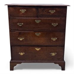 18th century oak chest, the rectangular top above an arrangement of two short over three long drawers fitted with brass batwing handles and escutcheons, raised upon shaped bracket feet
