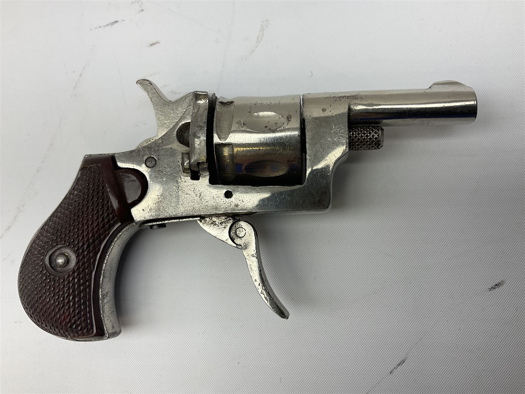 Early 20th century Flobert 5mm blank firing revolver with six-shot chamber, top venting, nickel plated with folding trigger No.118 L12.5cm overall; replica non-firing 'British Bulldog' revolver; and Windproof gas lighter inscribed 'Revolver-99 Spring and Autumn' in holster marked 'Star-Line'