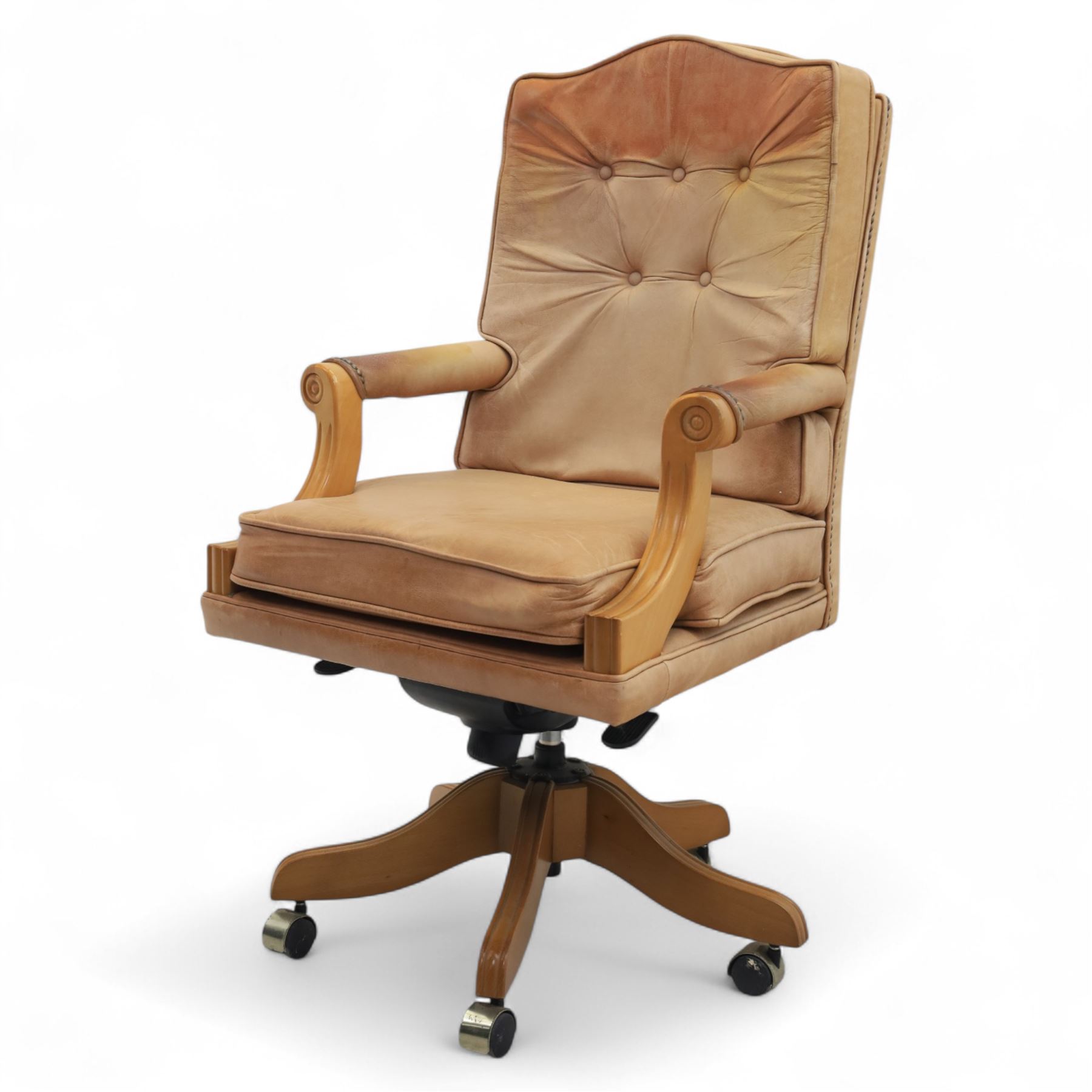 Late 20th century swivel executive desk chair, upholstered in tan leather with brass studded trim, raised on five point base raised on castors 