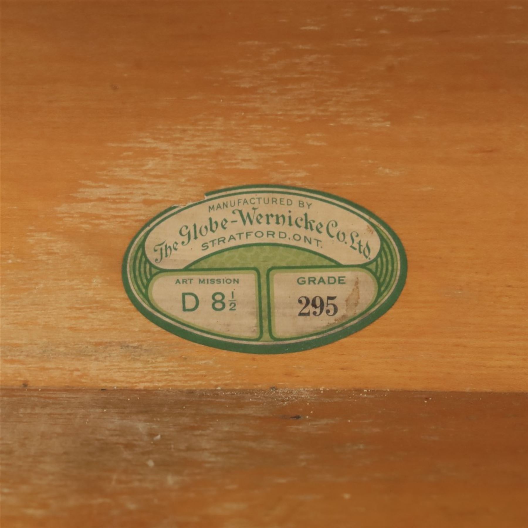 Globe Wernicke - Modular oak sectional bookcase, the three glazed up-and-over doors with panelled sides, raised on a plinth base with square supports