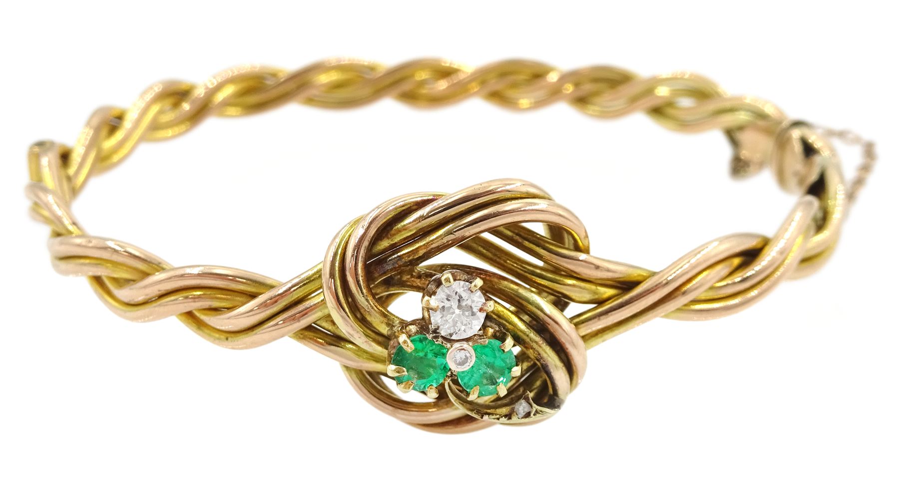 Early 20th century rose gold weave and knot hinged bangle, the central knot with old cut diamond and emerald three leaf clover decoration, stamped 9ct, diamond approx 0.15 carat