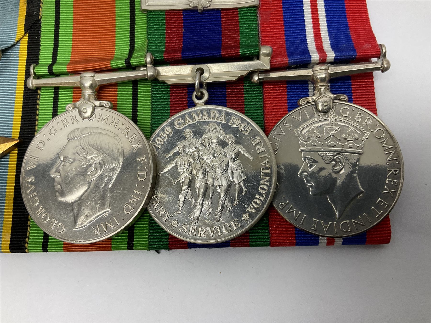 Group of five medals comprising 1939-1945 War Medal, Defence Medal, 1939-1945 Star, Air Crew Europe Star and Canadian Volunteer Service Medal with maple leaf clasp; all with ribbons and mounted on a display board