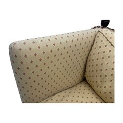 20th century Knole design two seat sofa, high back and double drop-arm joined by mahogany finials and ties, upholstered in camel ground fabric with red lozenge design, on turned supports with brass castors