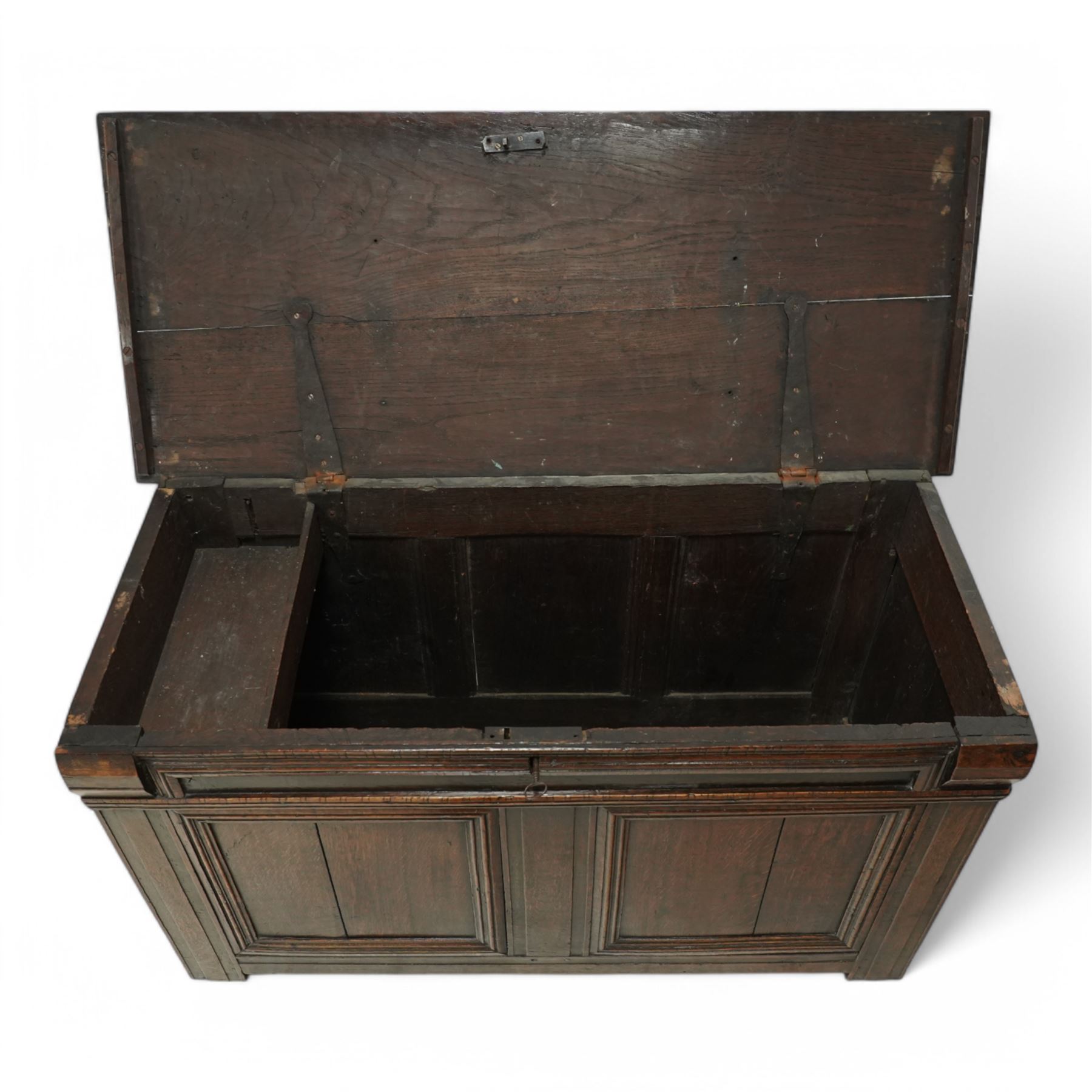 18th century oak blanket chest, chamfered rectangular hinged top over panelled front and sides, decorated with applied mouldings, on stile supports