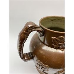 19th century salt glazed stoneware jug, with mask spout and greyhound modelled handle, the body decorated in relief with Royal Coat of Arms flanked by lions, the rim with the flowers of the union, roses, thistles and shamrocks, H26.5cm