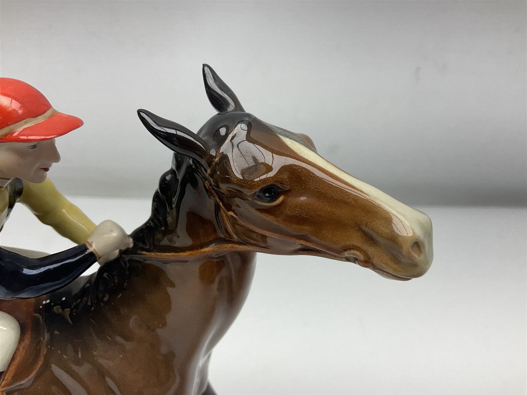 Beswick jockey on walking horse no 1037, in black white and yellow jockey colours, with printed mark beneath, H22cm