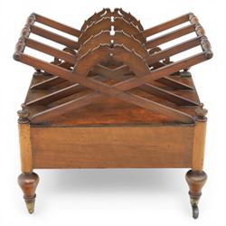 19th century mahogany music canterbury, with pierced dividers united by turned handles, above a single frieze drawer, raised upon baluster supports on brass castors