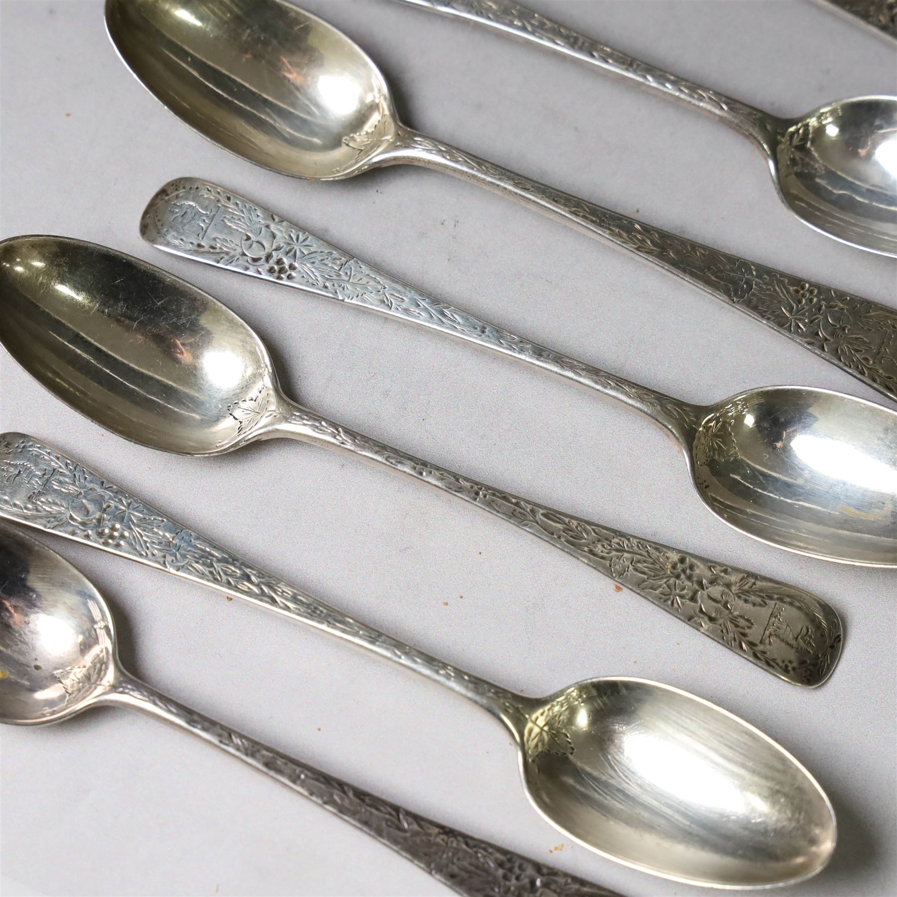 Eleven Victorian silver teaspoons, profusely engraved with floral decoration throughout with family crest to terminal, hallmarked Elkington & Co, Birmingham 1875