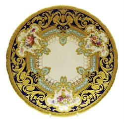  Royal Crown Derby shallow circular dish from the Judge Elbert Henry Gary service, circa 1910, hand painted by Albert Gregory, signed, with baskets of flowers in cartouche shaped panels on cobalt blue and turquoise ground with raised gilded border incorporating an oval medallion with the initial 'G' by George Darlington, signed, printed back stamp in gilt with Royal Warrant and Tiffany & Co retailer's mark, D23.5cm. Provenance Property of Bob Heath, Brandesburton Formerly of Ravenfield Hall Farm near Rotherham  