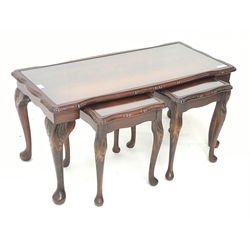 Late 20th century figured mahogany nest of tables, shaped moulded top with inset glass, on cabriole supports with leaf carved knees, 98cm x 45cm, H46cm