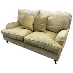 Multi-York - Howard shape two-seat sofa, upholstered in scrolling floral pattern loose covers, rolled arms, on turned front feet with brass cups and castors