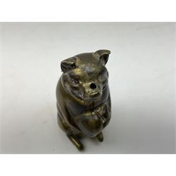 Victorian novelty brass vesta case modelled in the form of a pig holding a money bag, together with a silver vesta, hallmarked 