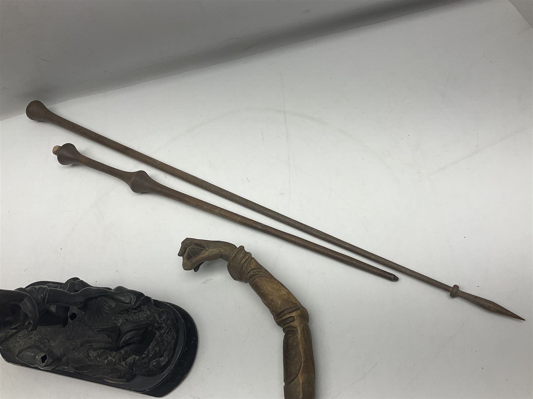 Spanish carved figure of Don Quixote, holding a book, base stamped 'Ouro, together with two spelter figures and one other