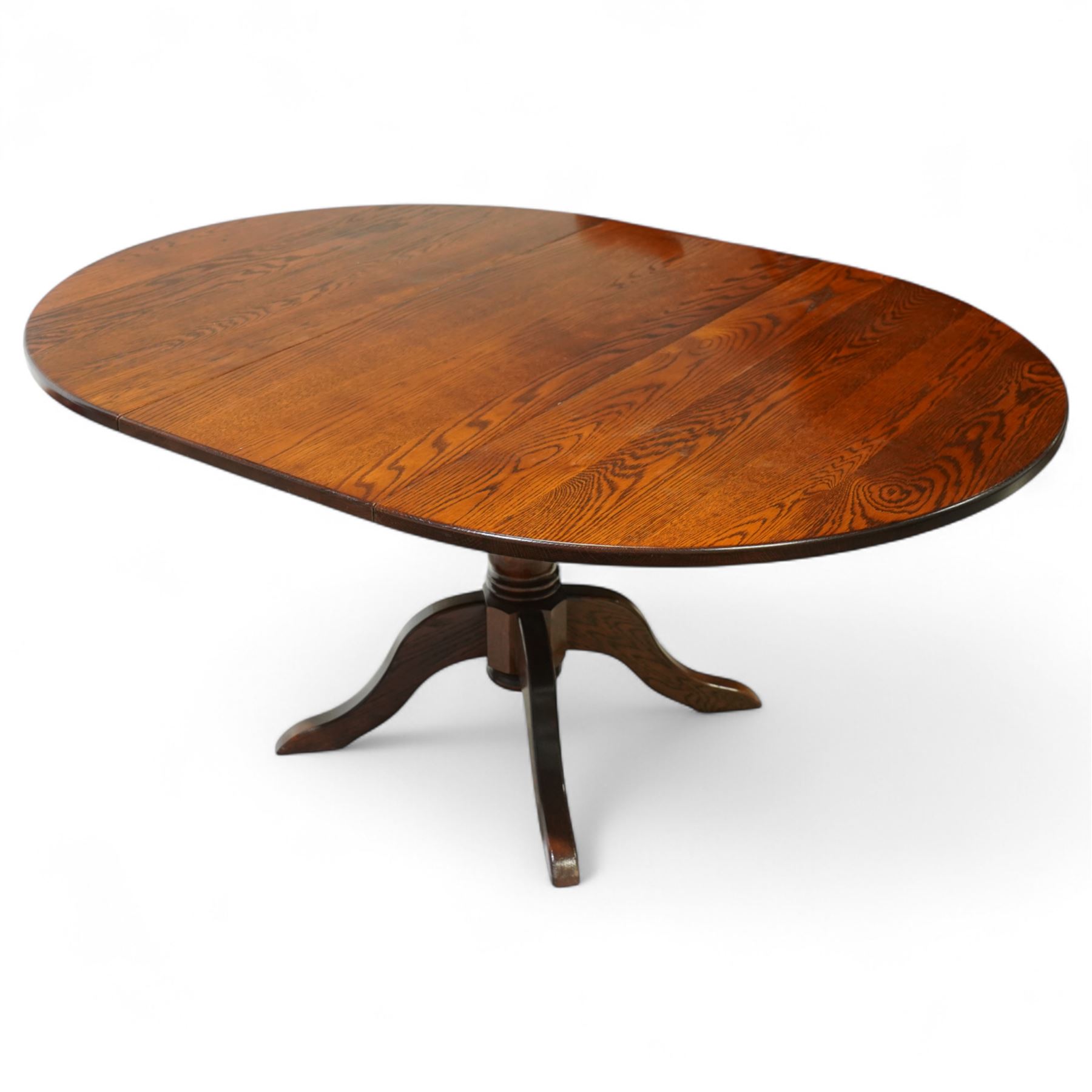 Late 20th century oak extending dining table, circular top with moulded edge, centre split revealing an additional leaf, on turned column support with four downswept legs (Extends to 165cm)