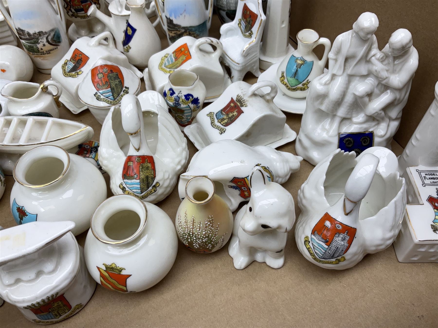 Collection of crested ware, to include Scarborough Willow Art coal truck, Whitby Willow Art Burns and Highland Mary figure group, Carlton China beer drinker 'Tak Hod an Sup Lad', and 'Here's ta me an'ma wife's usban', lighthouse, boat, Kingsway Art China Sir Walter Scott's Chair, butter dishes, candlestick, pianos etc