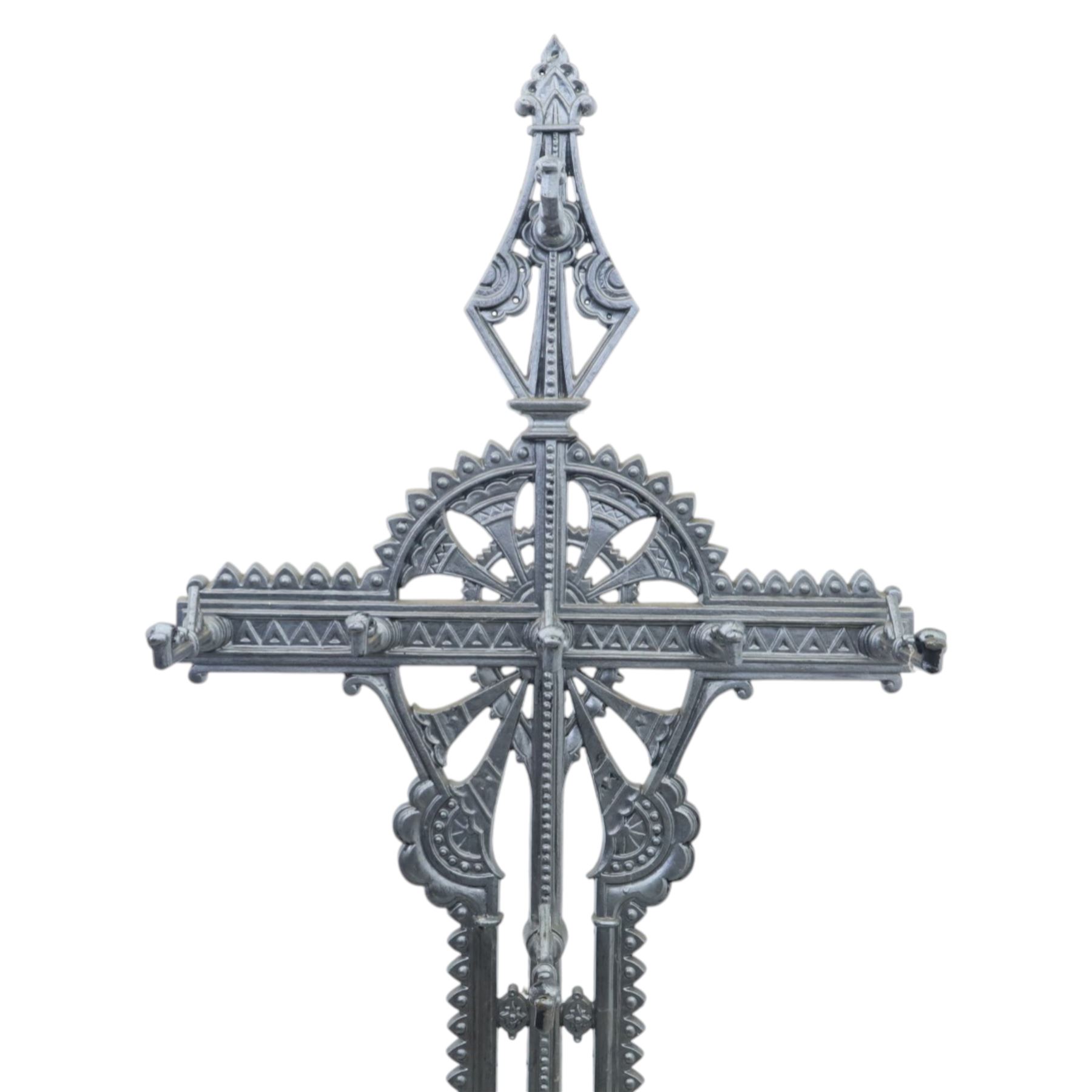 Late 19th century cast iron hall stand in the style of Christopher Dresser, cross shaped upper section with radiating wheel motif and applied hooks, architectural upright with pierced Gothic and geometric detail, fitted with rectangular drip tray and pierced surround, raised on stepped plinth base with bead decoration