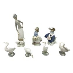 Collection of Lladro figures comprising May Flowers no. 5467, Pretty Pickings no. 5222, Girl with Geese no. 1035, together with four Lladro swan figures, all with printed and impressed marks beneath (7)