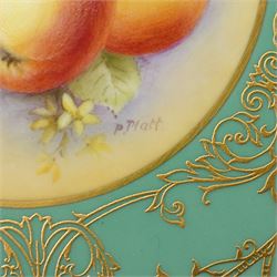 Pair of Royal Worcester cabinet plates painted with central panel of fruit by Peter Platt signed 'P Platt' within a green and gilt surround D27cm