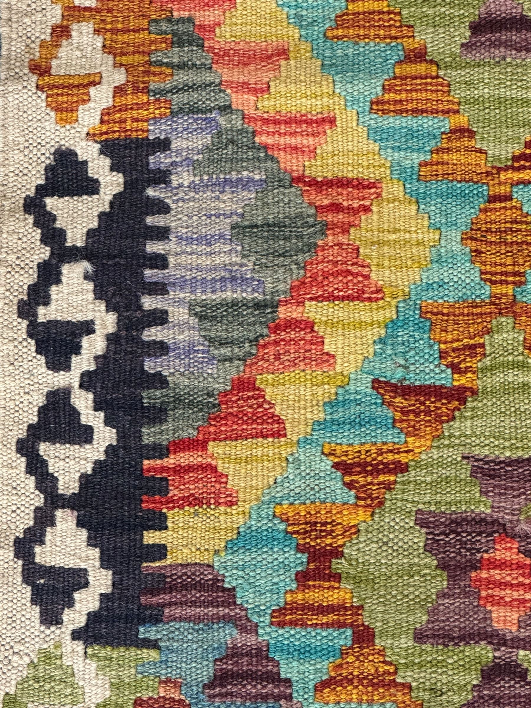 Tibetan-design handwoven rug, deep red field with three central medallions in yellow and blue, traditional yellow key border, white fringes on both ends