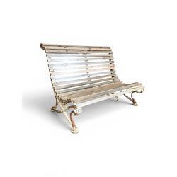 19th century cast iron and wood slatted garden bench, high scroll back form, low X shaped base, finished in distressed white paint