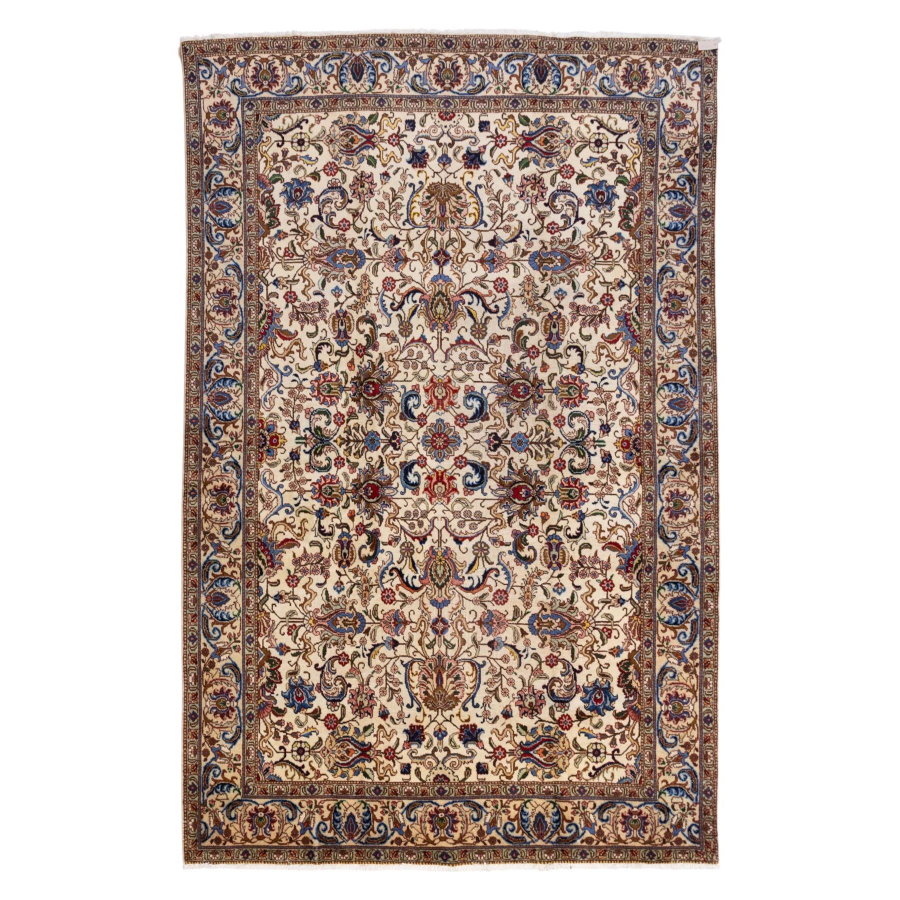 North West Persian Tabriz, hand-knotted carpet, ivory ground with dense scrolling vine-work, palmettes, flowering sprays, and stylized leaves framed by a principal border of scrolling floral motifs and palmettes and flanked by narrow guard borders, with cotton fringe ends