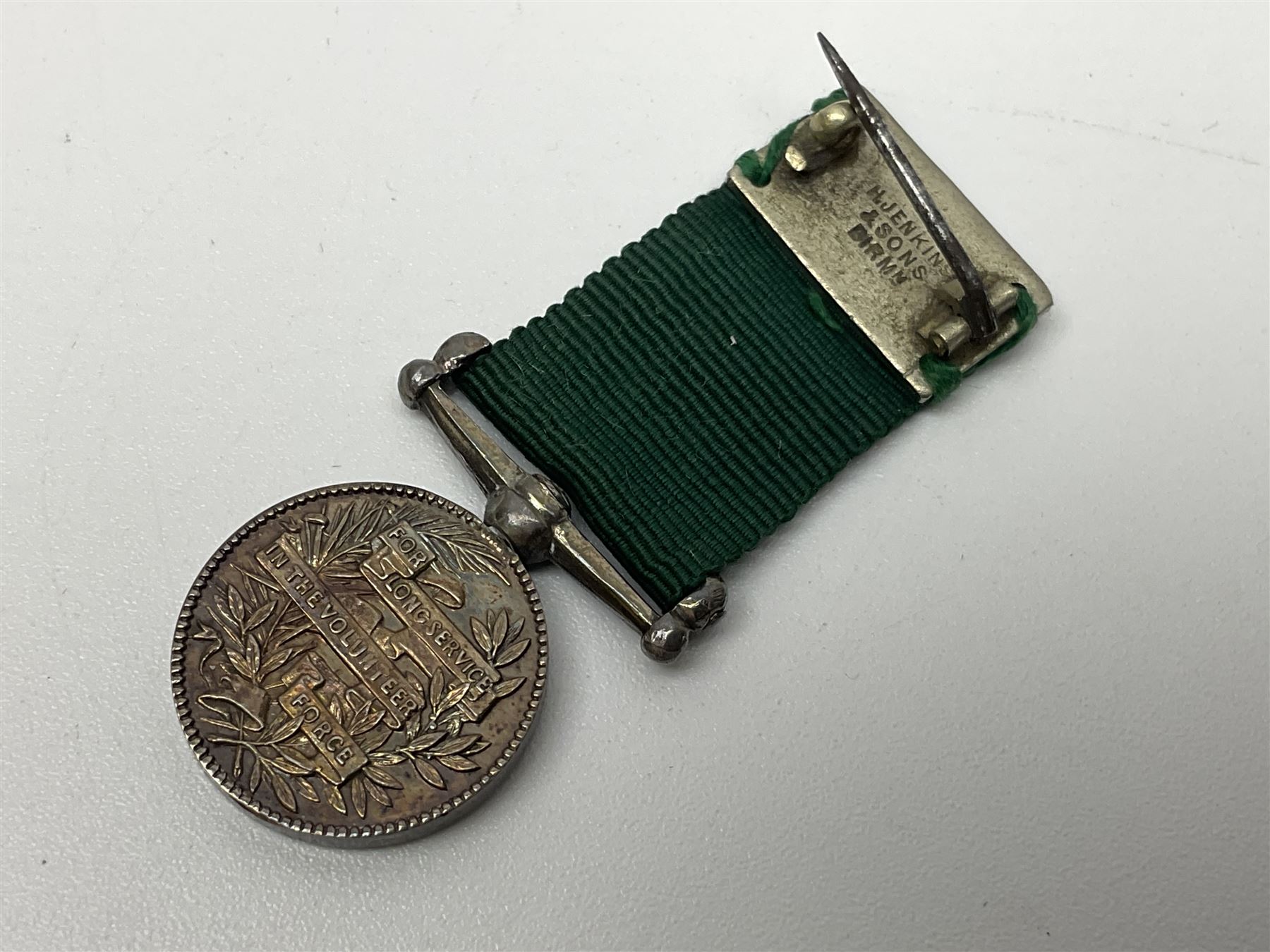 Victoria Volunteer Officers’ Decoration, V.R. cypher, hallmarked silver London 1892, with integral top riband bar and ribbon, unnamed; the matching miniature; and Victoria 'For Long Service in the Volunteer Force' miniature medal with ribbon in original case (3)