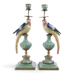 Pair candlesticks, modelled as parrots, upon urn shaped mounts with gilt detail, H48cm