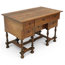 19th-century Louis XIV design French walnut bureau Mazarin, rectangular top above central drawer and recessed drawer flanked by two rows of small drawers,  supported on baluster turned legs united by an H-form stretcher, raised on bun feet 