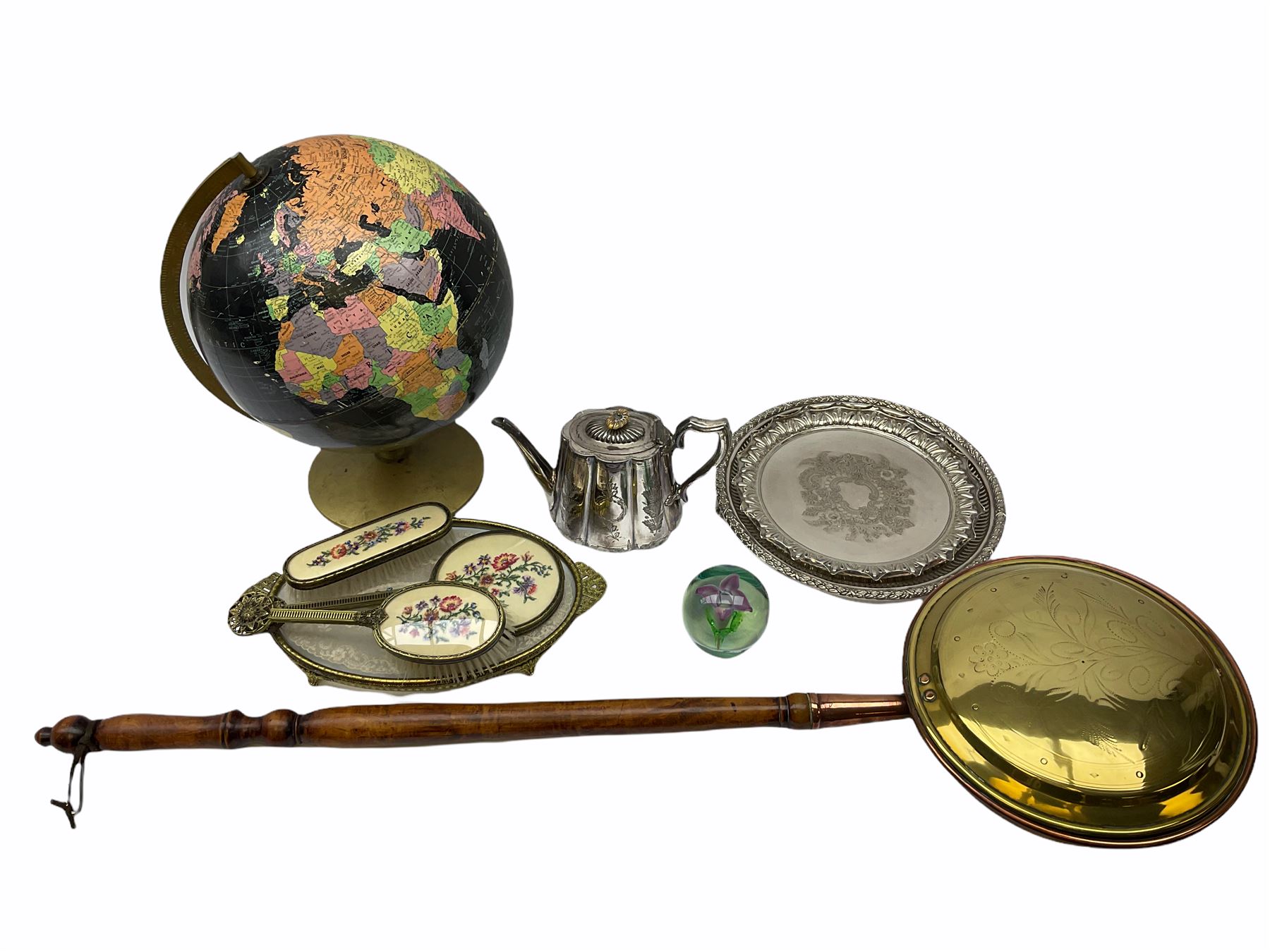ladies vanity set with floral embroidery backs, comprising mirror, two brushes, comb and tray, along with paperweight with internal floral design, brass and copper bedwarmer, two metal serving trays, a metal teapot and a globe. 