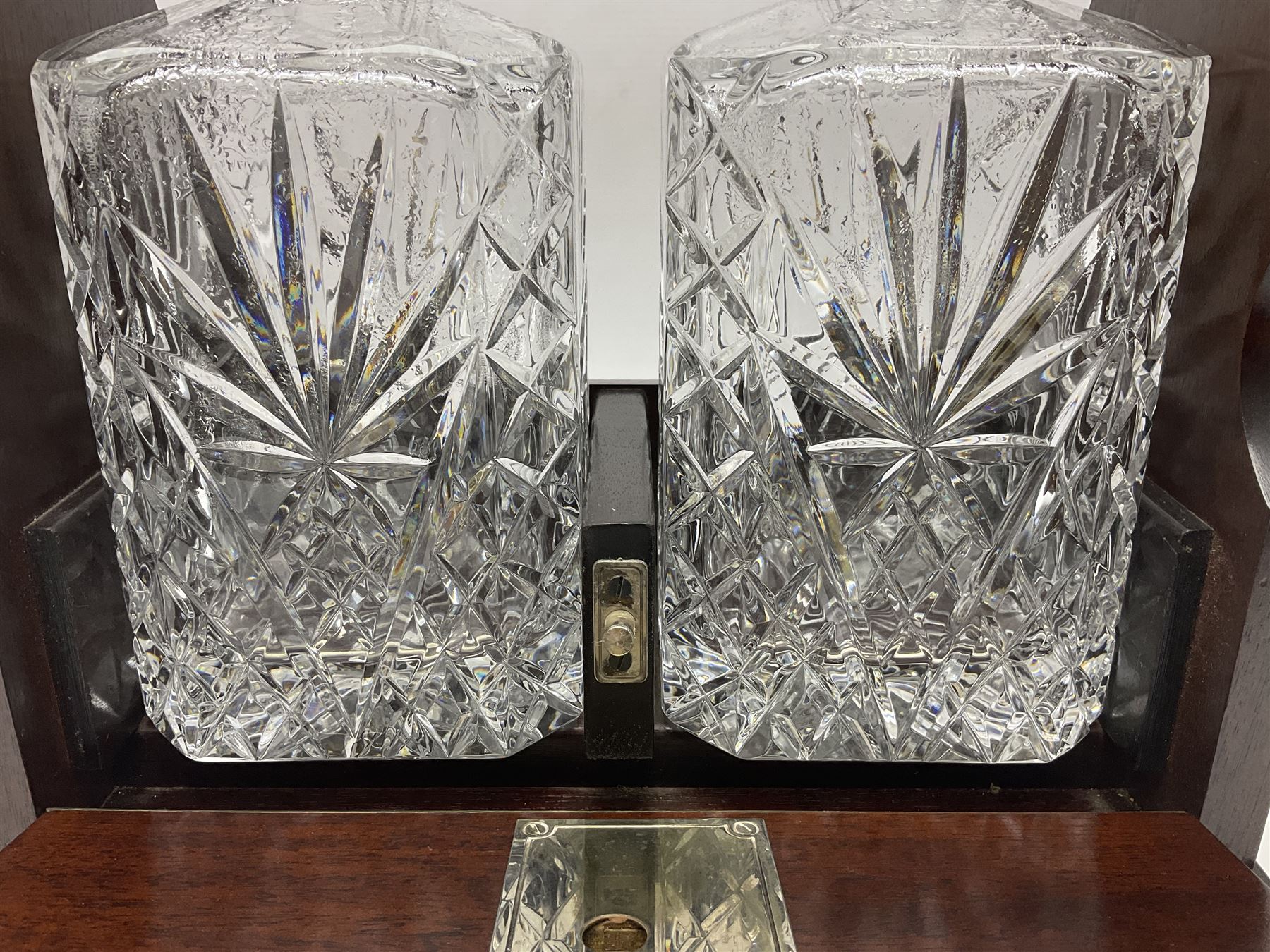 20th century mahogany tantalus with plated mounts and handle, with two recesses containing two square sided cut glass decanters, with key, including handle H36cm W27cm