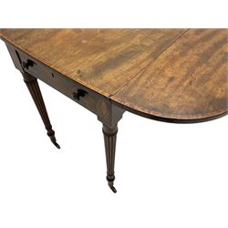 George III mahogany Pembroke table, drop-leaf oval top with satinwood band, fitted with single end drawer, inlaid with satinwood lozenge motifs, on turned and reeded supports with brass cups and castors