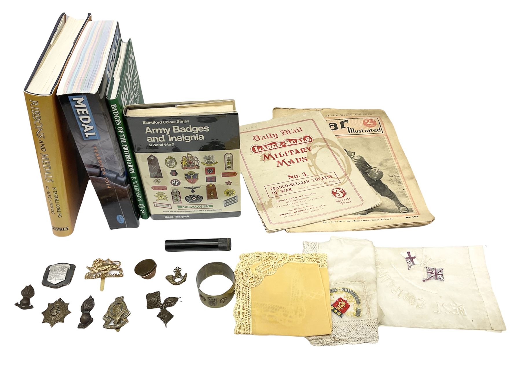 Three WW1 embroidered silk handkerchiefs including RAF & RN; trench art brass napkin ring inscribed 'Arras' and miniature peaked cap with inset 1914 penny; small quantity of cap badges and pips; four reference books on medals and badges etc