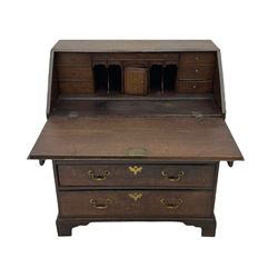 Georgian oak bureau, fall front enclosing fitted interior, four long graduating drawers, on bracket feet