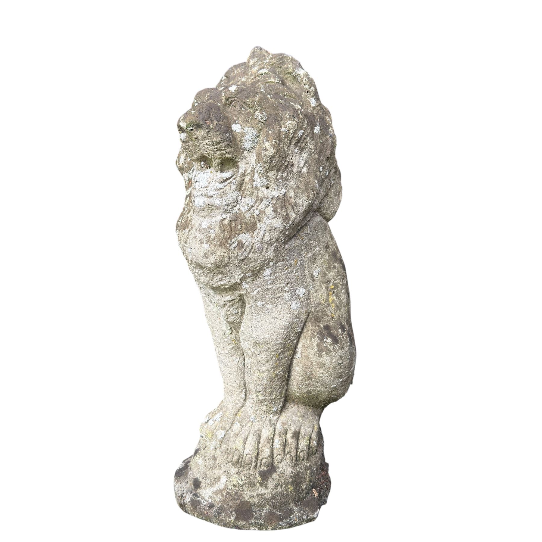 Four weathered cast stone lions in seated poses