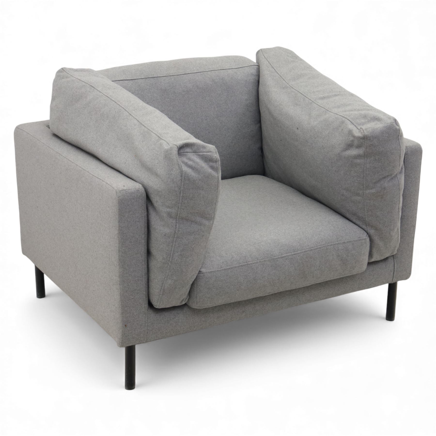 Modern snuggler armchair, upholstered in grey fabric, box-shaped frame with loose back and side cushions, raised on slender black metal legs