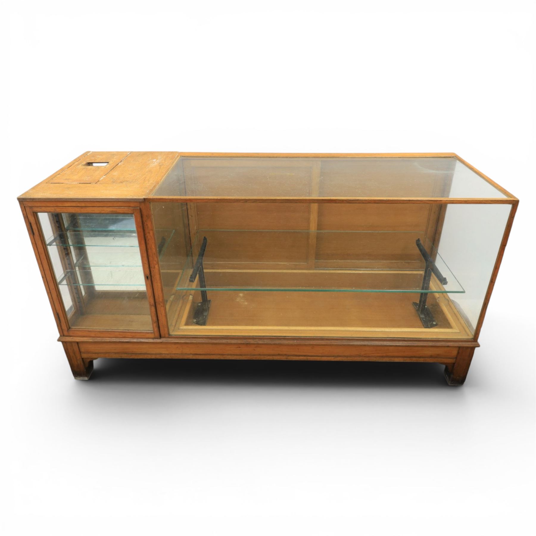Early 20th century oak framed and glazed haberdashery shop counter with sliding doors and cupboards