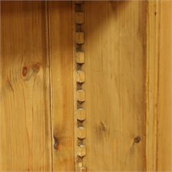 Traditional large pine bookcase, moulded cornice above five adjustable shelves