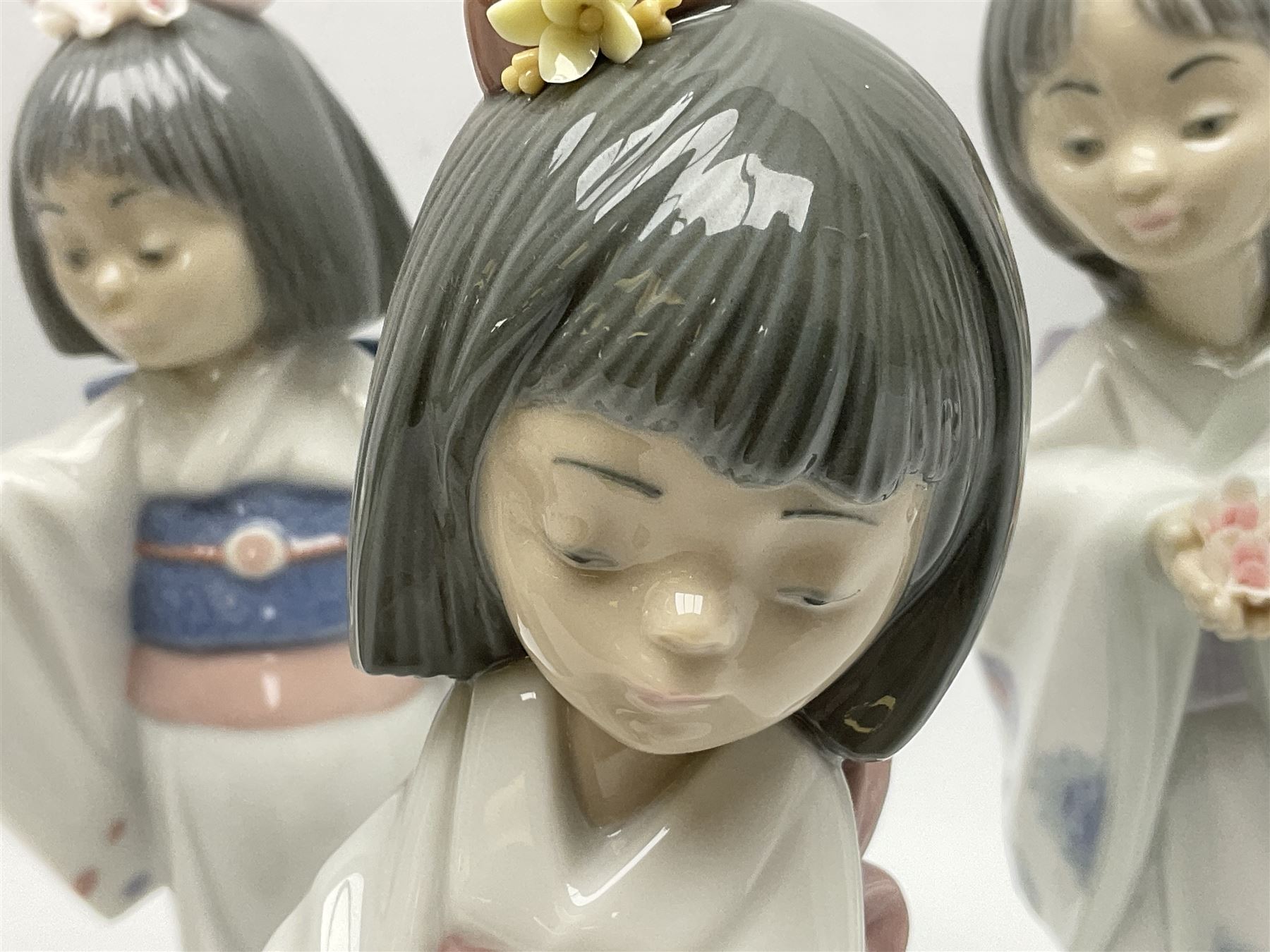 Six Lladro figures of the China doll set and Oriental doll set, comprising Playing the Flute no.6150, Bearing Flowers no.6151, Flower Gazer no. 6152, Oriental Dance no. 6230, Oriental Lantern no. 6231 and Oriental Beauty no. 6232, largest H20cm