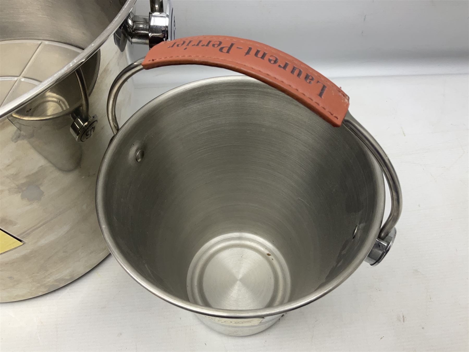 Stainless steel Laurent-Perrier champagne bucket, with engraved brass plaque and grip to swing handle, together with two matching smaller, largest D38cm (3)