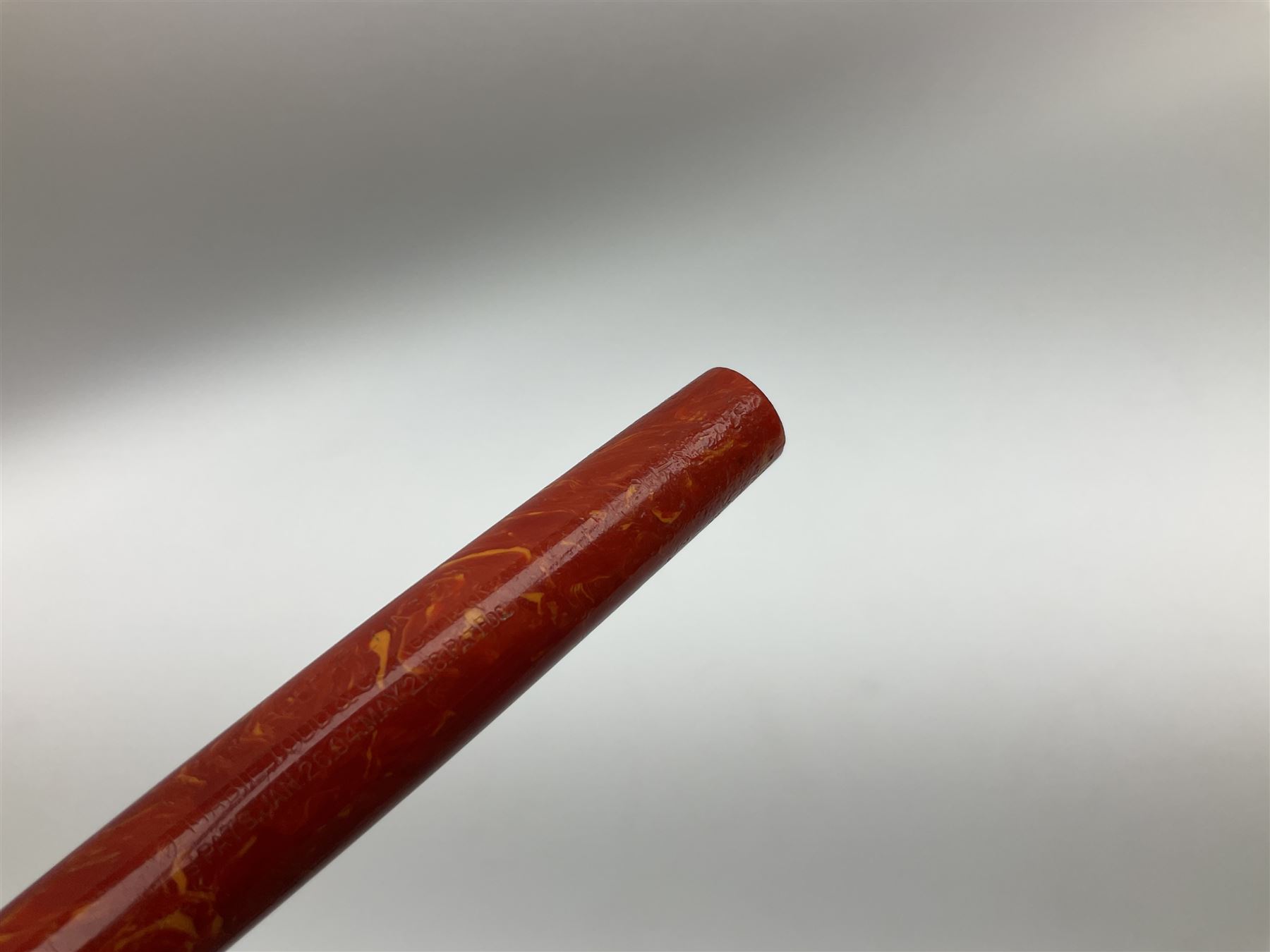 Vintage Swan Mabie Todd lever fill fountain pen in coral red, the nib a/f marked 14K, together with two further vintage Swan Mabie Todd fountain pens, the first example with lever fill, the other leverless, each with black body, one with nib marked 14ct, (3) 